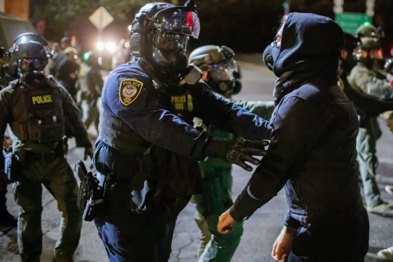 Protesters confront federal law enforcement officers outside a U.S. Immigration and Customs Enforcement facility in Portland, Ore., Monday, Oct. 6, 2025.