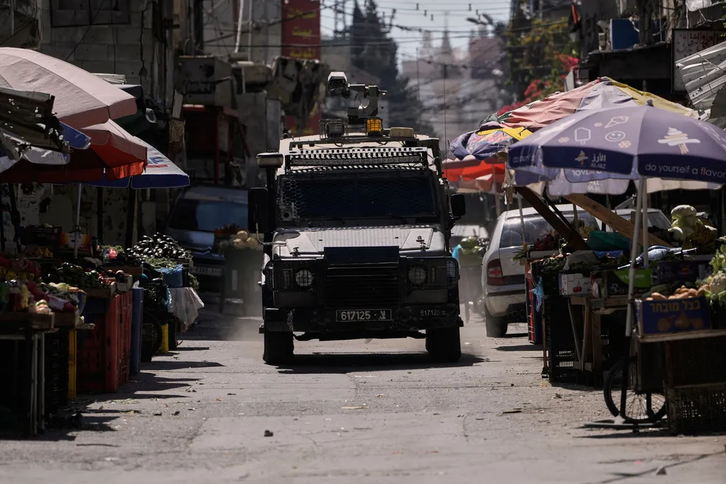 Israeli armored vehicle in a West Bank market.