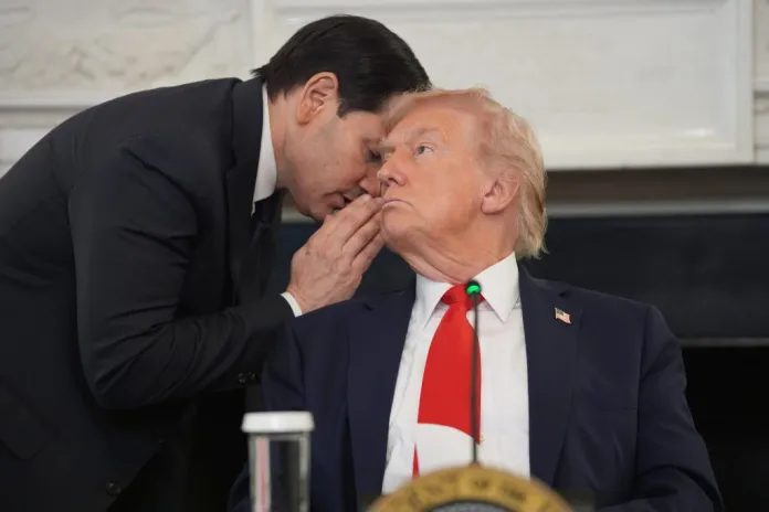 Secretary of State Marco Rubio whispers to President Donald Trump.