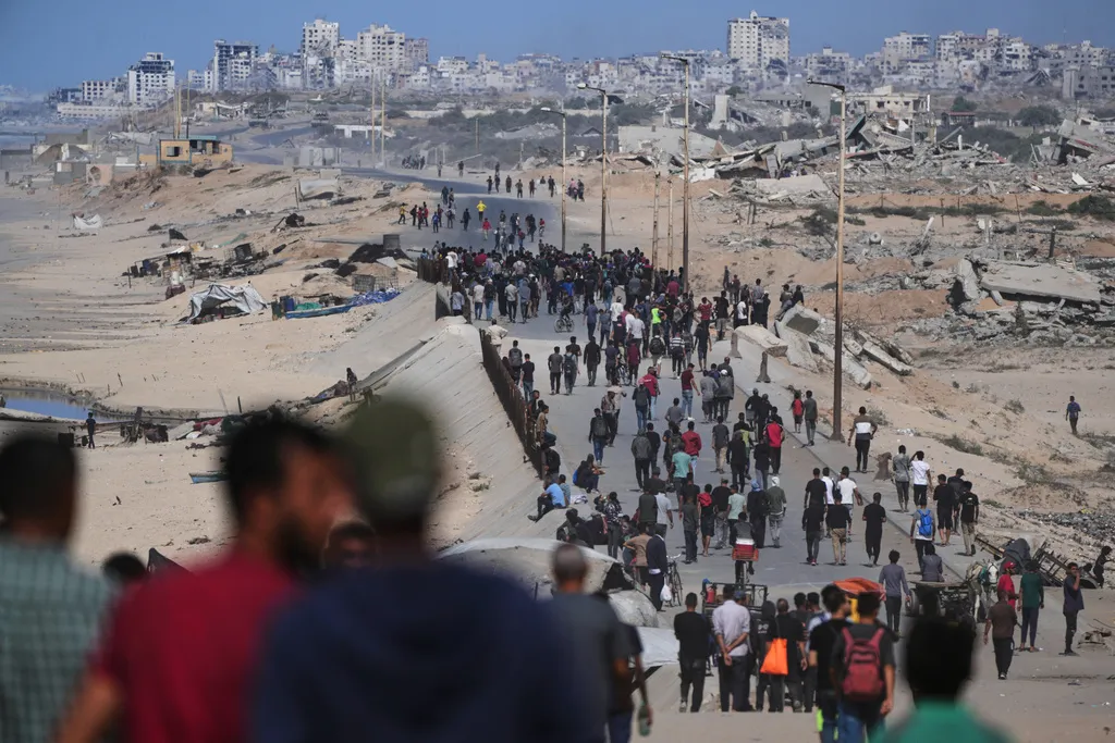 Israel and Gaza celebrate Trumps unprecedented ceasefire plan, but long road remains to everlasting peace 4 Displaced Palestinians gather on the coastal road near Wadi Gaza.