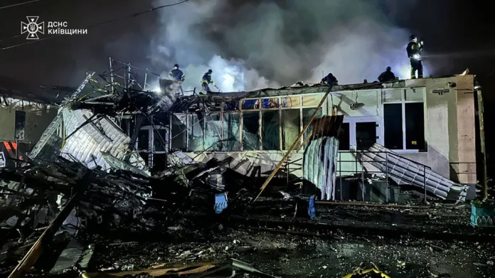 Emergency services personnel work to extinguish a fire.