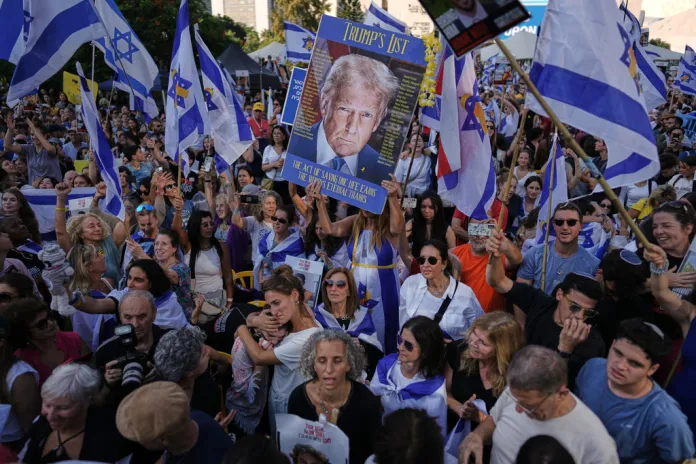 Trump poster held by those celebrating the release of the hostages in Tel Aviv.