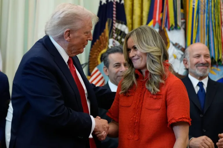 President Donald Trump shakes hands with Libby Horne, senior vice president at EMD Serono.