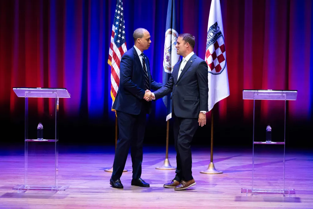Democrat Jay Jones, left, and Republican incumbent Jason Miyares shake hands at the start of the Virginia attorney general debate