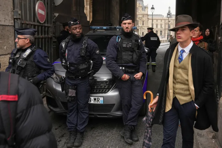 Police officers block an access to the Louvre museum after a robbery Sunday, Oct. 19, 2025, in Paris.