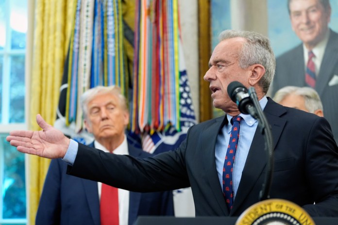 Health and Human Services Secretary Robert F. Kennedy Jr. speaks in the Oval Office of the White House as President Donald Trump looks on.