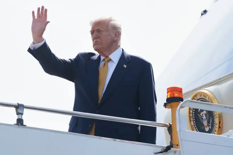 President Donald Trump waves outside of Air Force One.