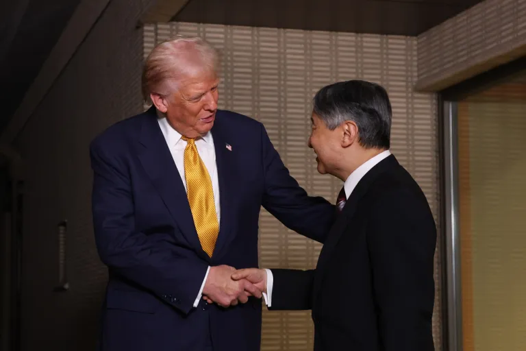 President Donald Trump, left, and Japan's Emperor Naruhito shake hands during their meeting at the Imperial Palace in Tokyo, Oct. 27, 2025. (Issei Kato/Pool Photo via AP)