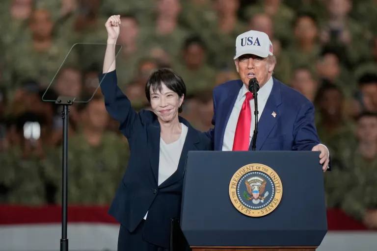 Japanese Prime Minister Sanae Takaichi, left, gestures as U.S. President Donald Trump delivers his speech.