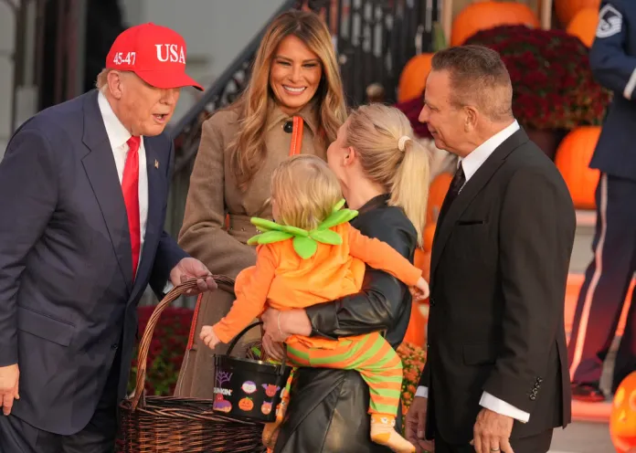 President Donald Trump and first lady Melania Trump greet press secretary Karoline Leavitt and her family at a Halloween 