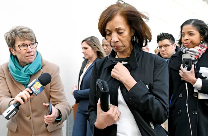 Former Baltimore Mayor Catherine Pugh, center, leaves U.S. district court, Feb. 27, 2020. Pugh was sentenced to three years in federal prison for arranging fraudulent sales of her self-published children’s books to nonprofit groups and foundations. (Steve Ruark / AP)