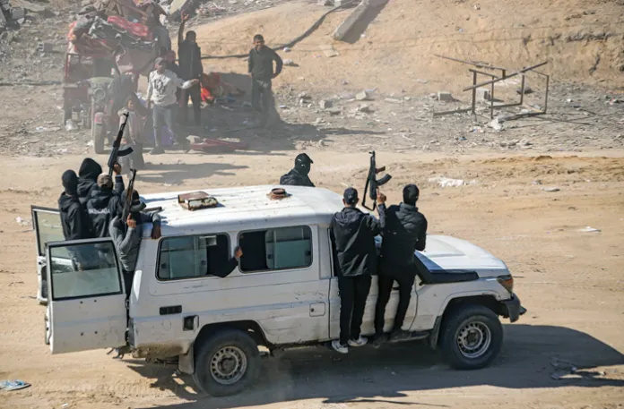Hamas fighters secure aid trucks in Rafah, Gaza Strip, Jan. 21, 2025. (Jehad Alshrafi/AP)