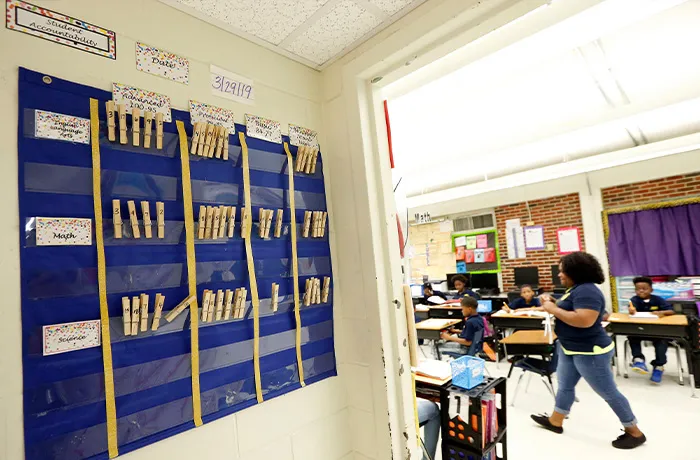 Key Elementary School third grade teacher April Tate, right, leads the class in a reading exercise, Thursday, April 18, 2019, in Jackson, Miss. A tally board with numbered clothespins show students where they stand in their reading skills. More than 35,000 Mississippi third graders sat down in front of computers this week to take reading tests, facing a state mandate to 
