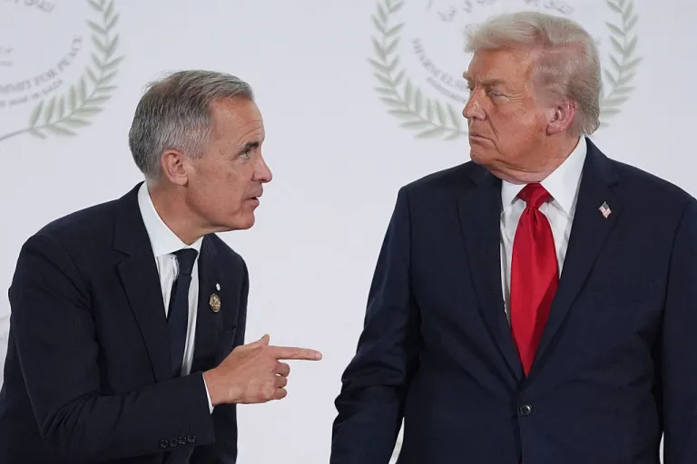 US President Donald Trump greets Canada's Prime Minister Mark Carney during a summit on Gaza in Sharm el-Sheikh on October 13, 2025. Trump landed in Egypt on October 13 for a summit on Gaza, following a lightning visit to Israel after a ceasefire he brokered entered into force. (Photo by Evan Vucci / POOL / AFP) (Photo by EVAN VUCCI/POOL/AFP via Getty Images)