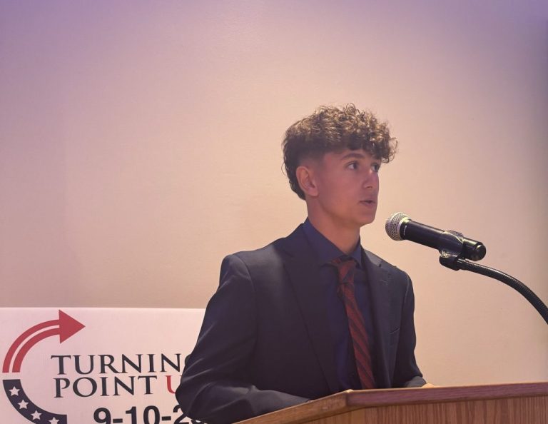 Collin Arthrell, 15, of Jefferson Hill, Pennsylvania, a Mon Valley suburb, speaks at a podium.
