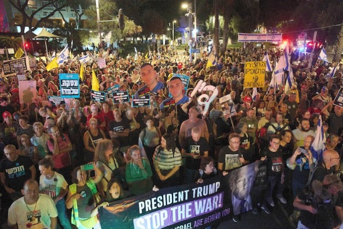 Demonstrators march in Tel Aviv, Israel, on Tuesday, Sept. 30, 2025, calling for the immediate release of all hostages held by Hamas in the Gaza Strip and an end to the ongoing war. (AP Photo/Ariel Schalit)