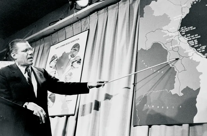 Secretary of Defense Robert McNamara points to a map of Vietnam during a press conference in Washington, D.C., on April 26, 1965. (Marion S Trikosko/PhotoQuest/Getty Images)