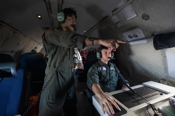 Missions System operator AET3 Caleb McLarty and AET-2 John Montalvo- Valentin onboard a HC-144B Maritime Patrol Aircraft use radar and other technologies to detect illegal fishing activities off the coast of Padre Island, Texas.
