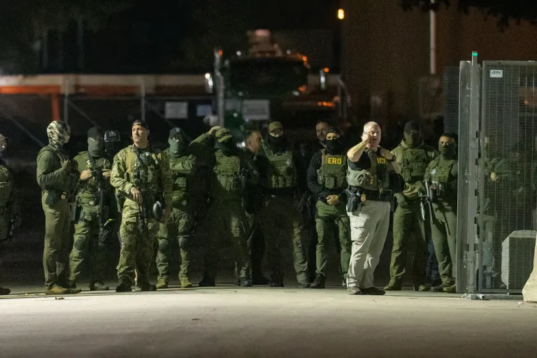 Law enforcement officers stand outside of a Chicago ICE facility