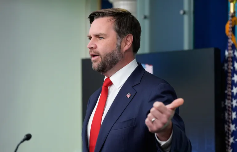 Vance speaks in front of a microphone