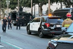 Man with signs referencing Trump barricades himself inside car outside Los Angeles City Hall