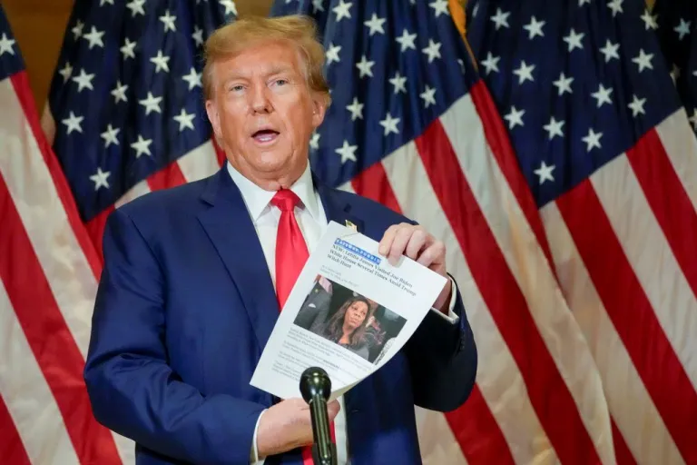 Trump holds up a newspaper article featuring Letitia James.
