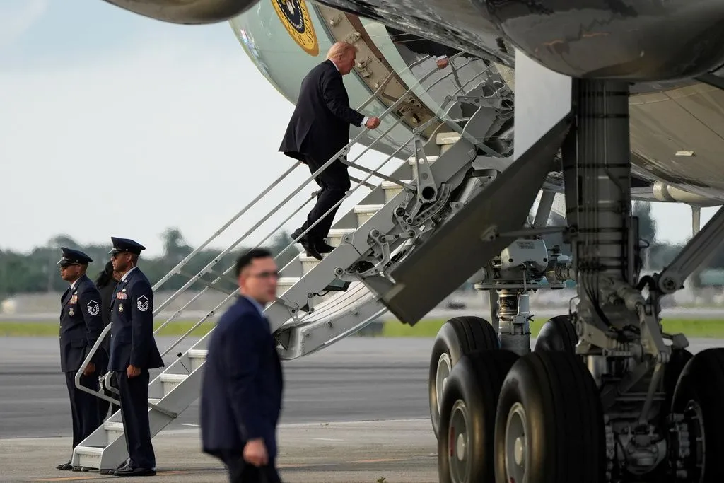 Trump boards Air Force One using small stairs after hunting stand found at airport