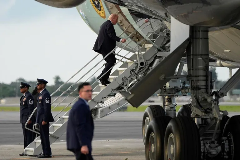 Trump using the small stairs to board Air Force One.