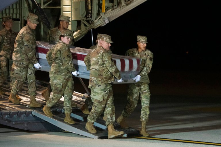 An Air Force carry team moves the transfer case containing the remains of Navy Seaman Apprentice Cameron Scott Walters.