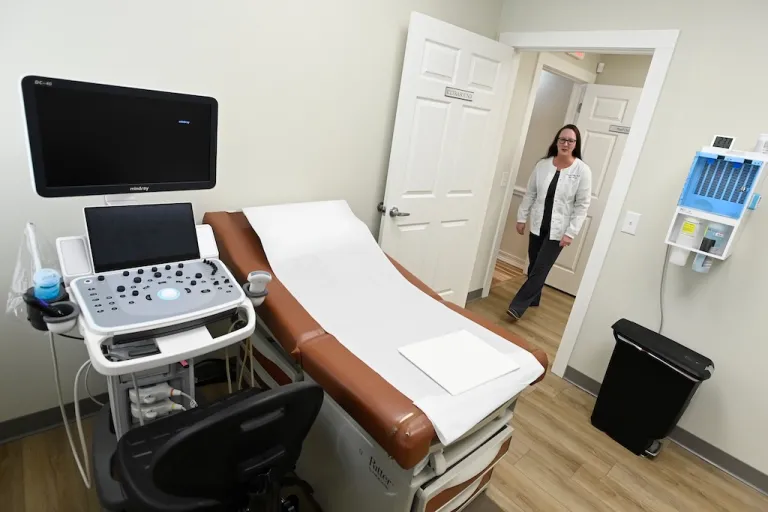Portico Crisis Pregnancy Center nurse manager Diandra Bell enters an ultrasound room.