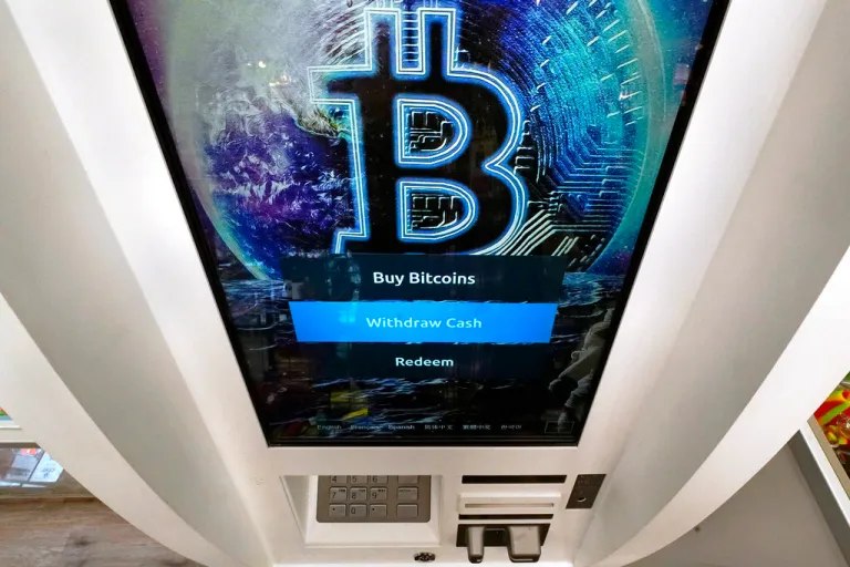 FILE - The Bitcoin logo appears on the display screen of a cryptocurrency ATM in Salem, N.H., Feb. 9, 2021. A bipartisan group of senators has proposed a bill to regulate cryptocurrencies. It's the latest attempt by Congress to formulate ideas on how to oversee a multibillion-dollar industry that has been racked recently by collapsing prices and lenders halting operations.