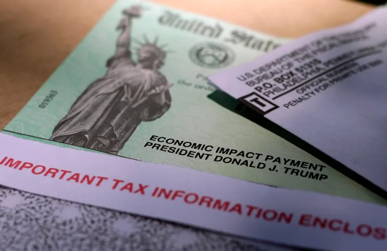 FILE - President Donald J. Trump's name is printed on a stimulus check issued by the IRS to help combat the adverse economic effects of the COVID-19 outbreak in this April 23, 2020 photo taken in San Antonio.