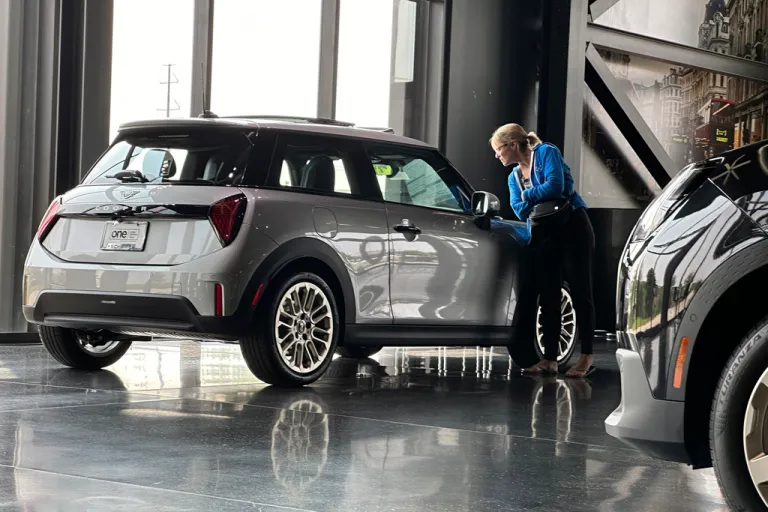 FILE - A prospective buyer looks over a 2025 Cooper S hardtop displayed at a Mini dealership on July 22, 2024, in Highlands Ranch, Colo.