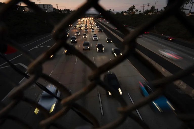 Traffic builds as cars make their way along a highway the day before Thanksgiving, Wednesday, Nov. 27, 2024, in San Diego. (AP Photo/Gregory Bull)