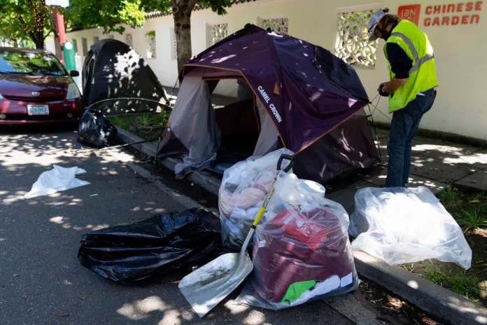 FILE - Contents of a tent are seen in bags as workers dismantle the tent after Portland police detained the person residing there on Friday, June 28, 2024, in Portland, Ore. (AP Photo/Jenny Kane, File)