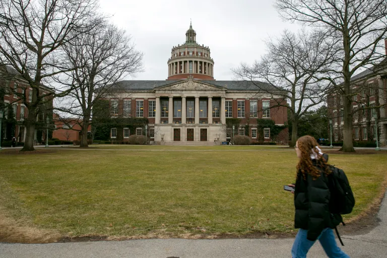 A student walks by the Rush Rhees Library at the University of Rochester.