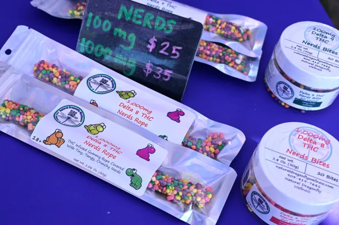 Delta 8 THC Nerds Rope gummies and Delta 8 THC Nerds Bites on a blue table.
