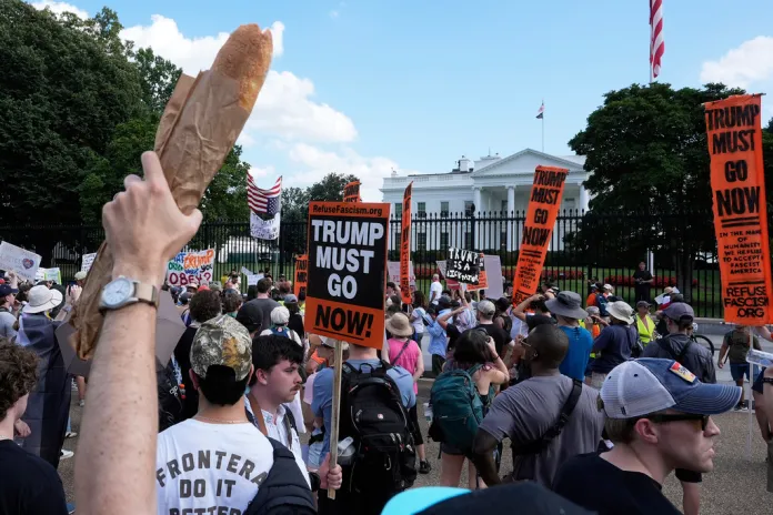 An activist holds up a baguette during an anti-Trump protest.