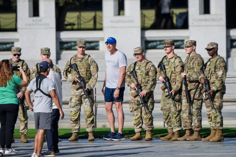 Doug Collins, center, poses for a photo with National Guard troops.
