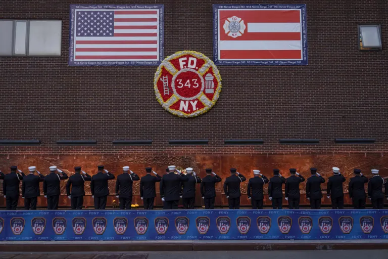 People take part in the annual Sunset Ceremony, to remember the 343 FDNY members who died during the 9/11 attacks, Thursday, Sept. 11, 2025 in New York. (AP Photo/Adam Gray)