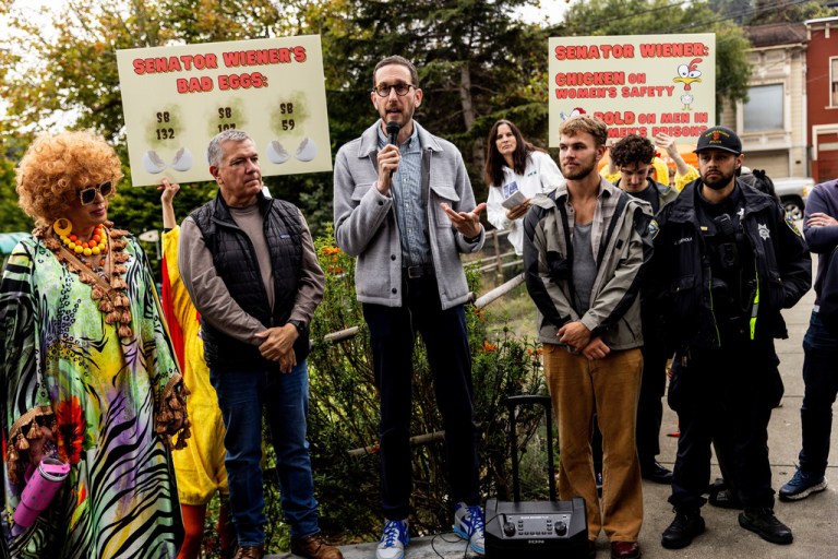 Scott Wiener, center, speaks during an annual pumpkin carving