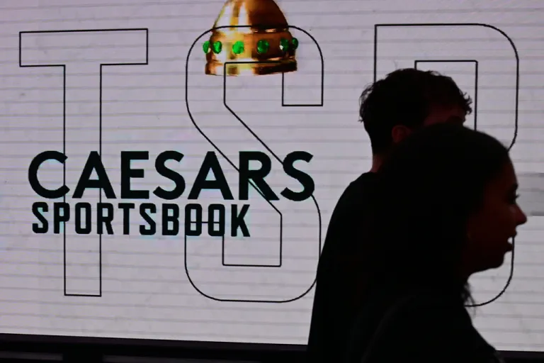 Fans walk past a sports gambling advertisement before an NBA basketball game between the Milwaukee Bucks and the Cleveland Cavaliers, Sunday, Oct. 26, 2025, in Cleveland.