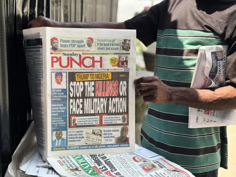 A vendor sells local newspapers with headlines referring to President Donald Trump's comments about Nigeria.