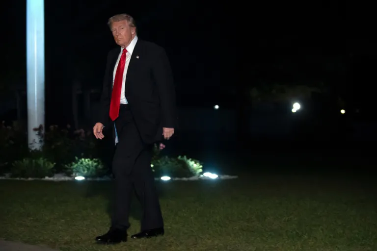 President Donald Trump walks across the South Lawn of the White House
