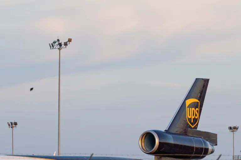 The tail engine of a UPS MD-11 plane against the sky.