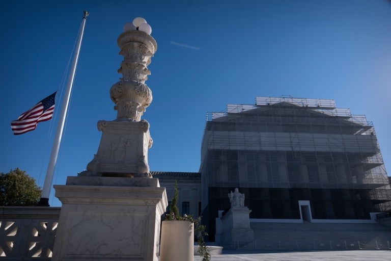 An American flag flies at half-staff outside the Supreme Court.