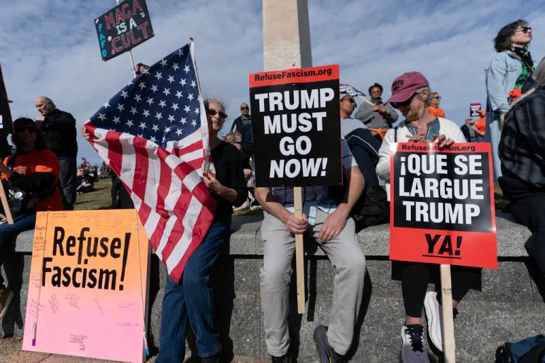 Demonstrators protest at the Washington Monument during a Trump Must Go Now rally.