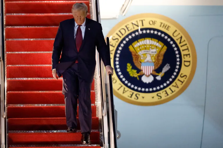 President Donald Trump walks down the stairs of Air Force One.