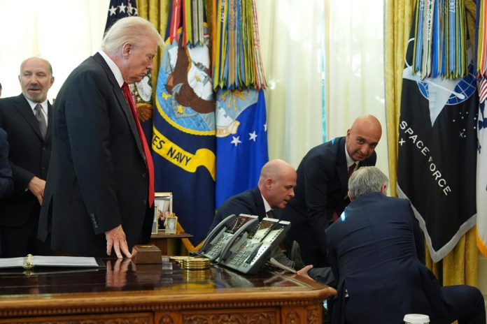 From left, Commerce Secretary Howard Lutnick, President Donald Trump, Novo Nordisk Inc. President David Moore, Novo Nordisk President and CEO Mike Doustdar, and Mehmet Oz, Centers for Medicare & Medicaid Services administrator look on after a person collapsed.