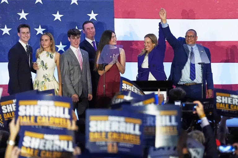 FILE - New Jersey Governor-elect Mikie Sherrill and Lieutenant Governor-elect Dale Caldwell, celebrate their victories in East Brunswick, N.J., Nov. 4, 2025. (AP Photo/Matt Rourke, File)